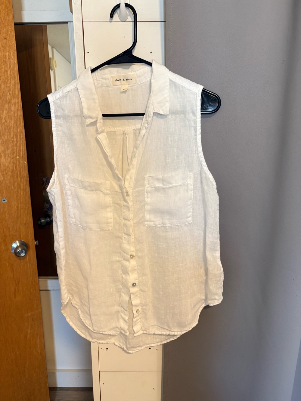 Sleeveless white button down linen shirt